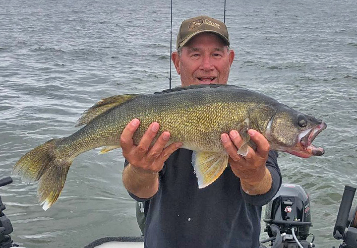 image of fisherman with big walleye caught on Lake of the Woods